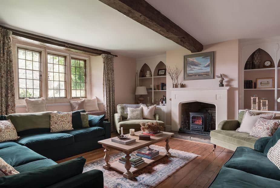 Cottage living room with sofas, wood burner and exposed ceiling beam