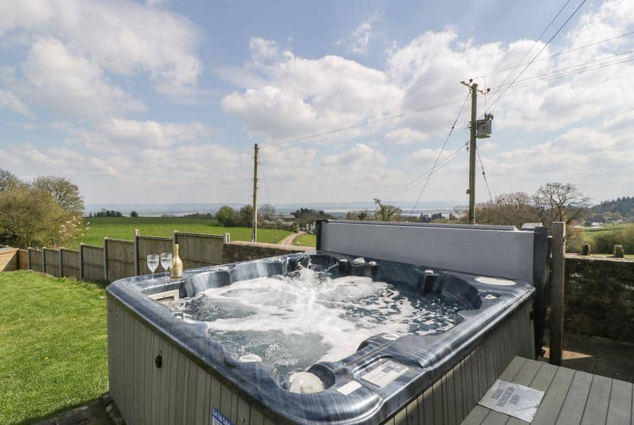 Hot tub in cottage garden with countryside view