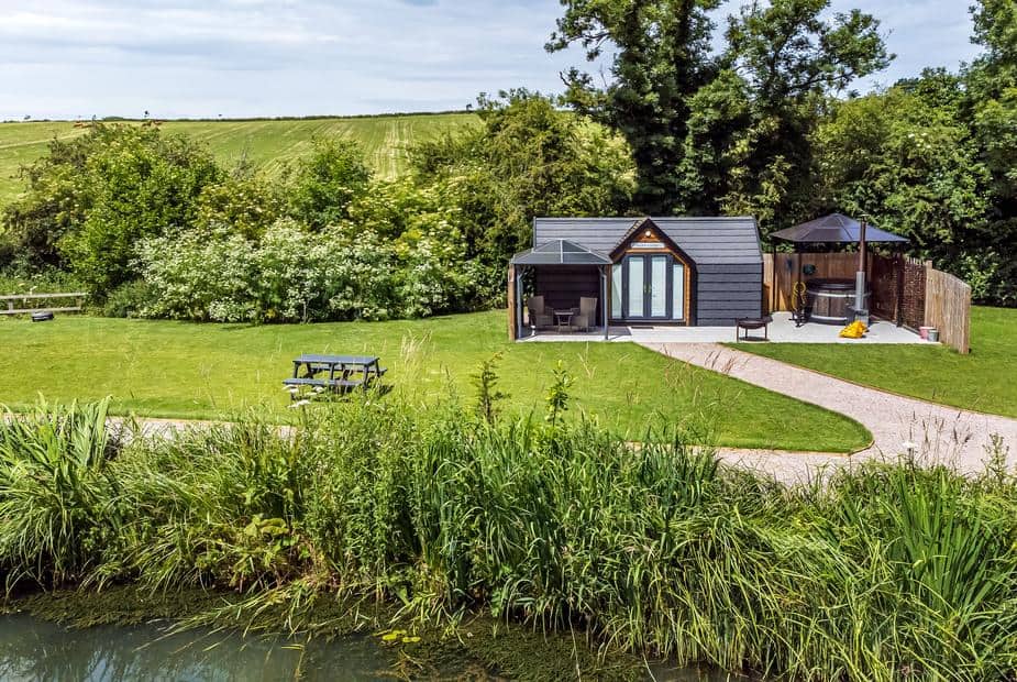 Acorn Lodge with outdoor hot tub, garden area and pond in a countryside setting