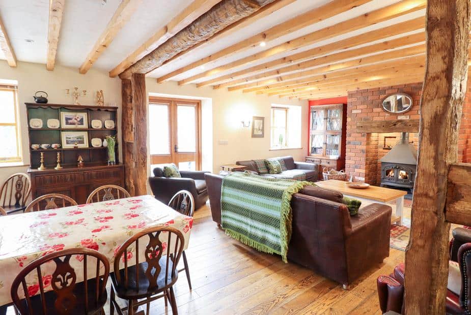Cottage open-plan lounge with wood burner and dining table