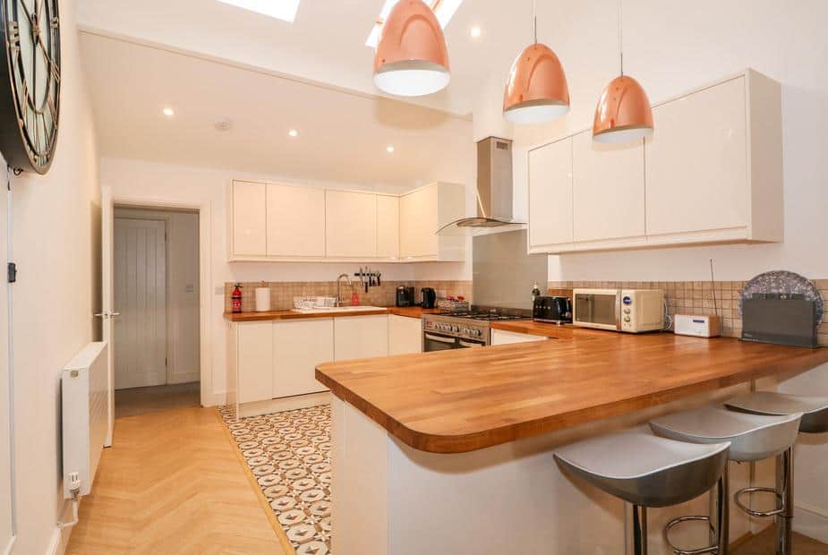 Kitchen with wooden worktops and breakfast bar with stools
