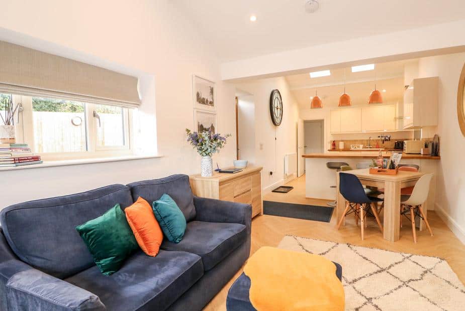 Cottage living room with sofa and open plan kitchen dining area