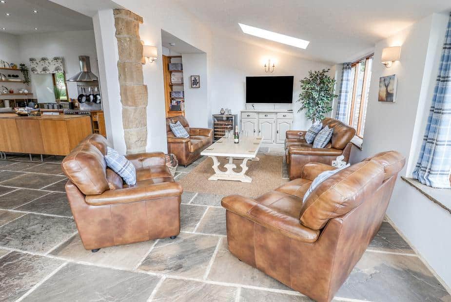 Cottage living room with leather sofas and wall-mounted TV