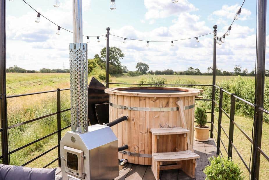 Lodge deck with wood-fired hot tub and countryside views