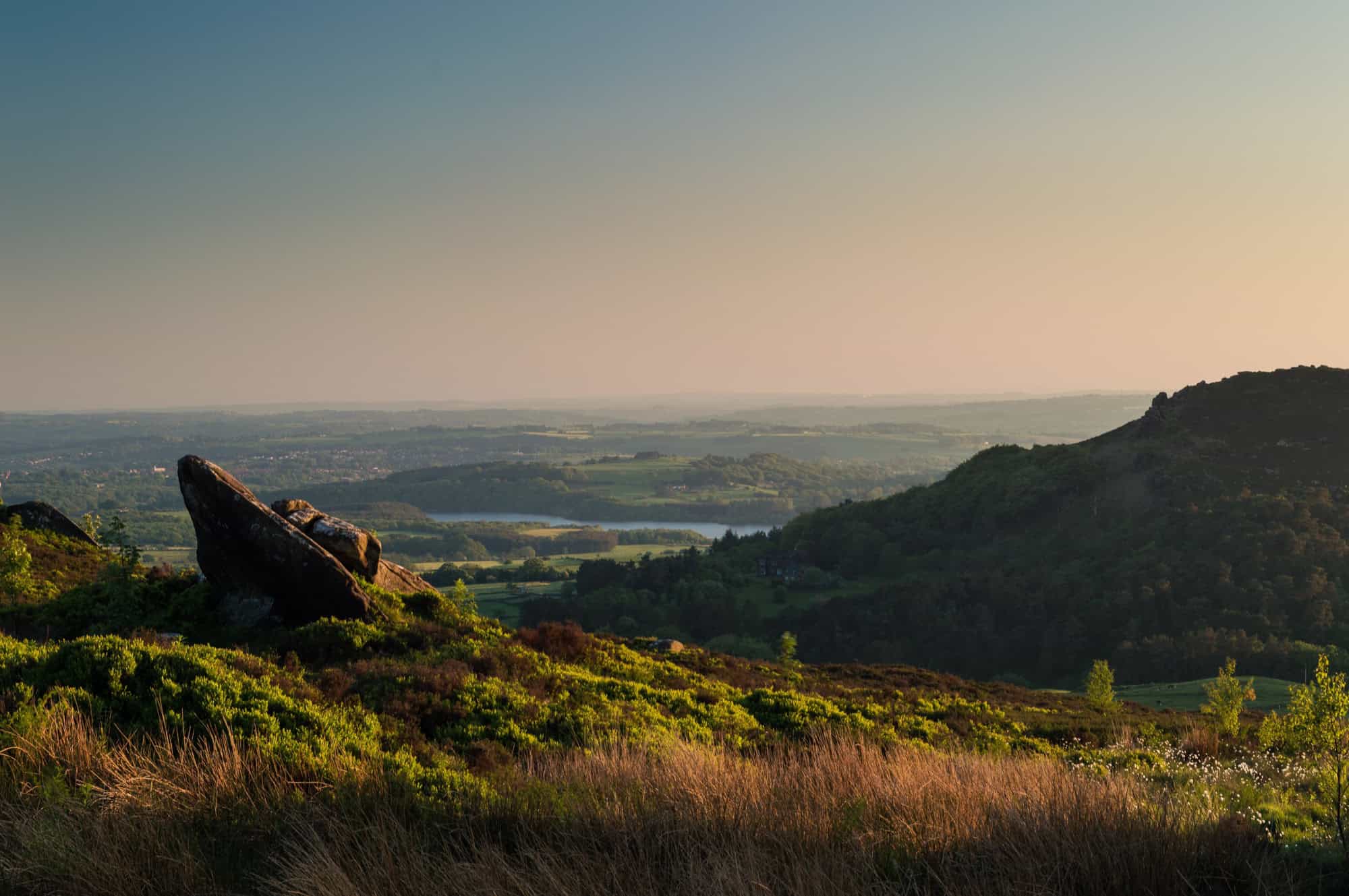 Sunset light illuminating the heather and rugged gritstone rocks at Ramshaw Rocks in the Staffordshire Moorlands.