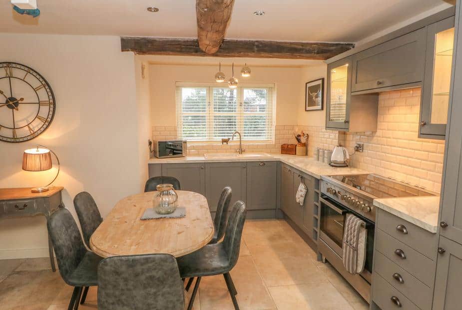 Kitchen with dining table and exposed ceiling beam