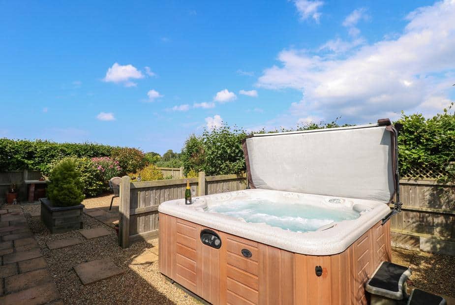 Cottage garden with hot tub and wooden fencing