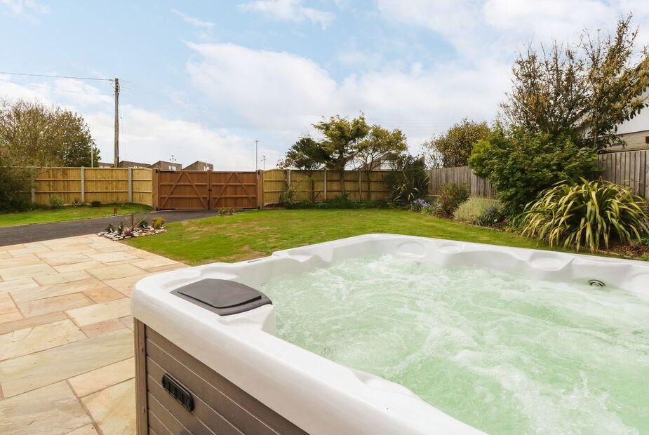 Cottage garden with hot tub and patio area