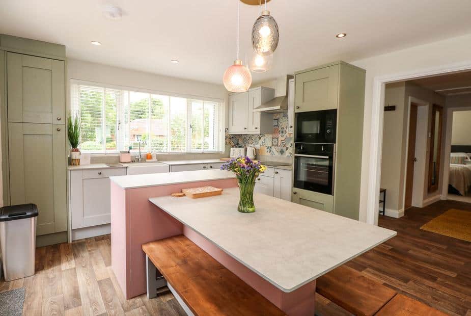 Kitchen with island, bench seating and built-in oven