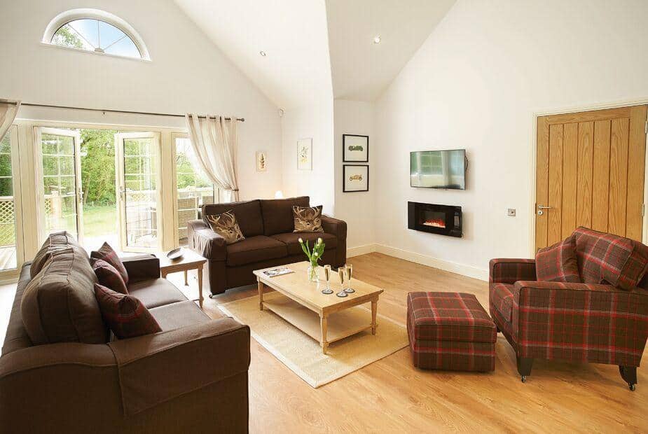 Lodge lounge with sofas, coffee table, and wall-mounted electric fire