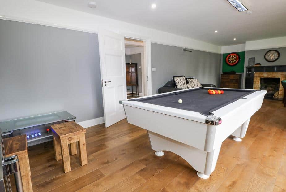 Games room in cottage with pool table and dartboard