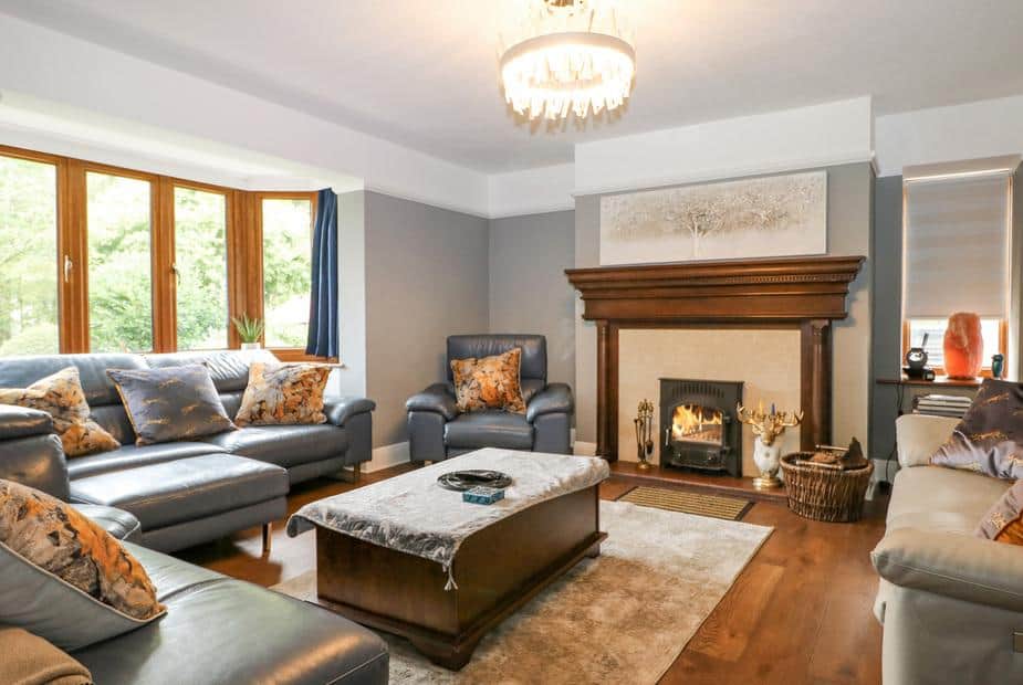 Cottage living room with sofas and wood-burning stove in fireplace