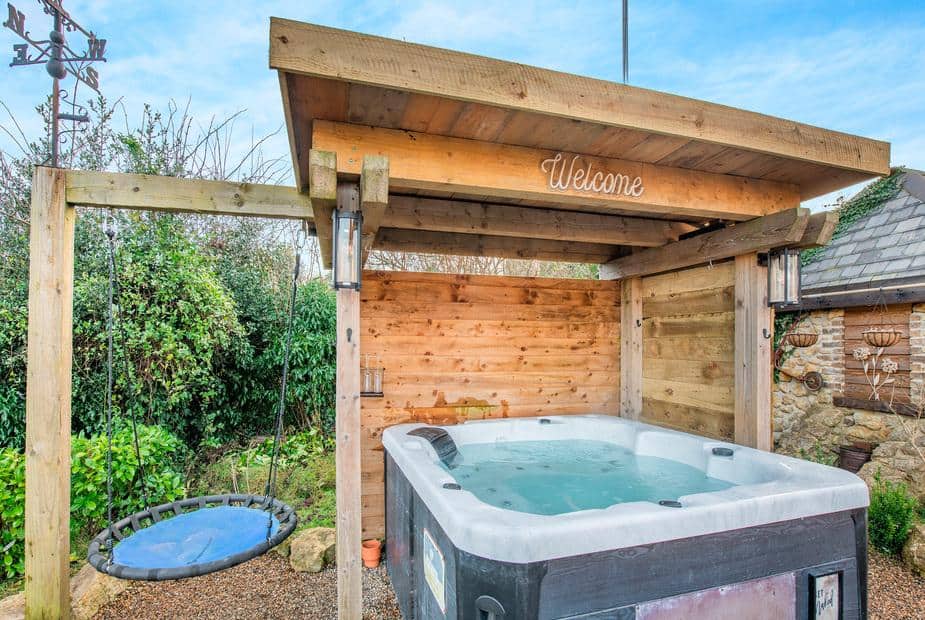 Cottage garden with covered hot tub and round swing