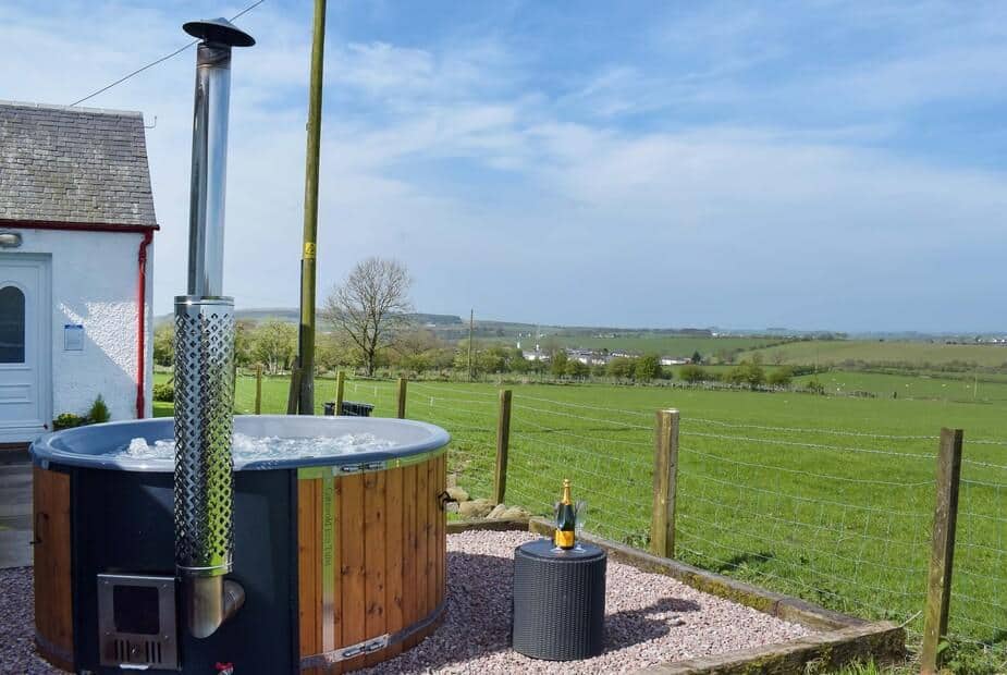 Cottage garden with wood-fired hot tub and countryside view