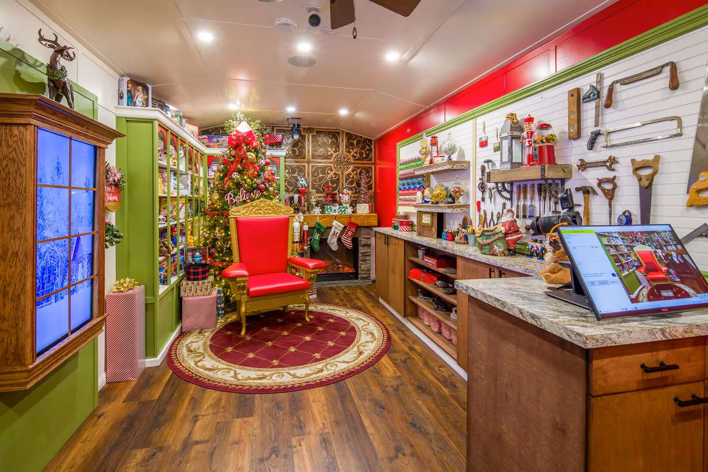 Holiday Magic Studios decorated Santa workshop set with golden throne, Christmas tree, toy-filled shelves and festive decorations