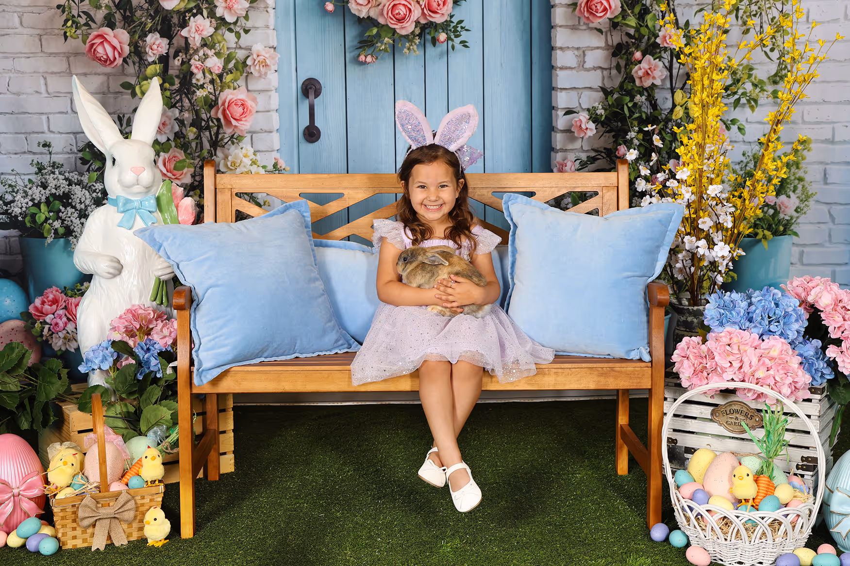 Young girl sitting with real-bearded Santa in decorated studio with Christmas tree and fireplace