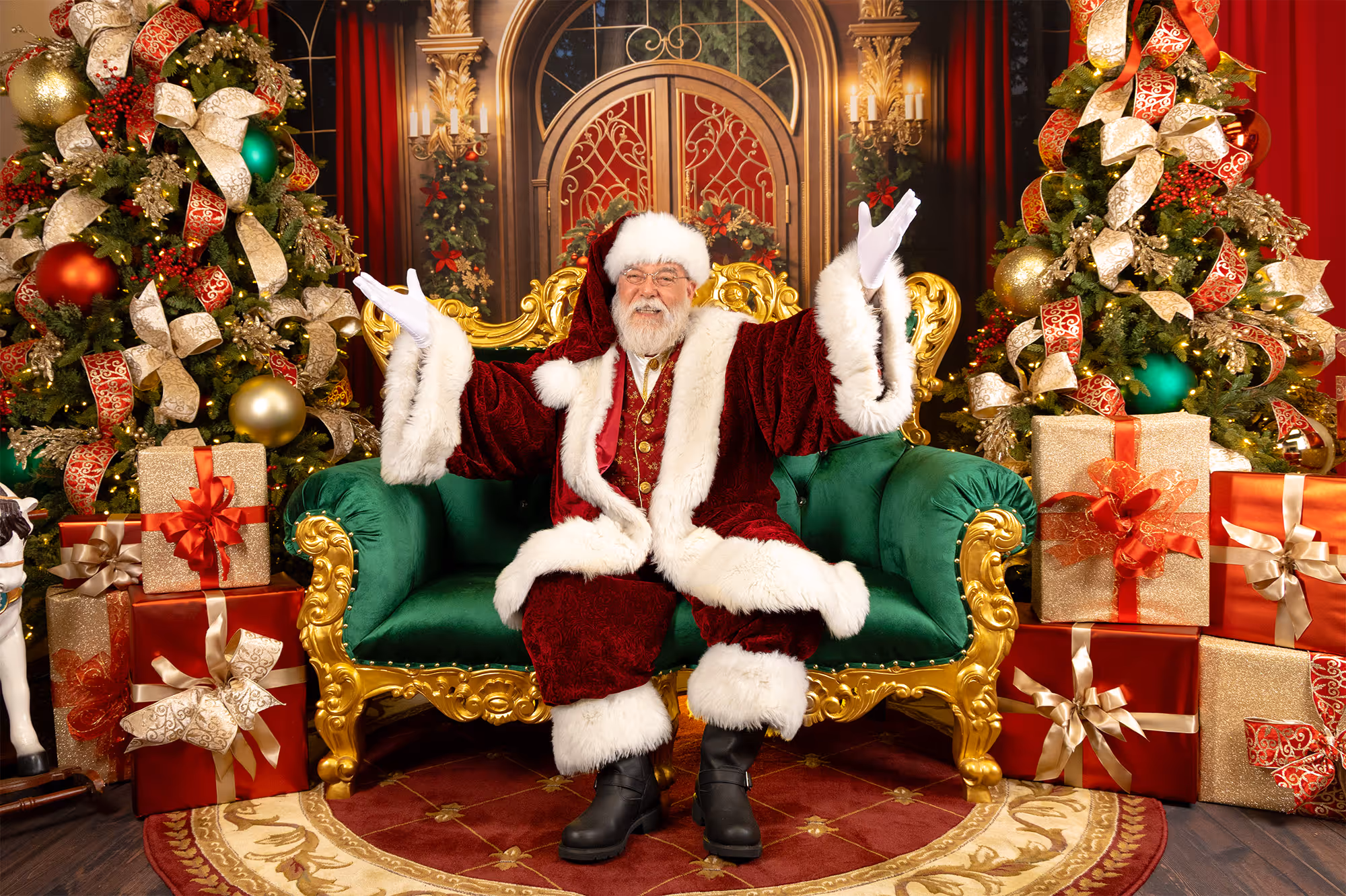 Santa smiling in a beautifully decorated, Christmas-themed photography studio