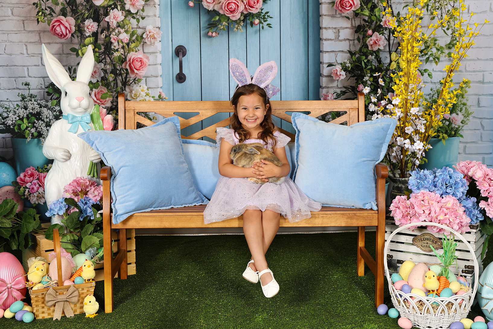Holiday Magic Studios exterior at dusk with illuminated garland, lit windows and poinsettia flowers