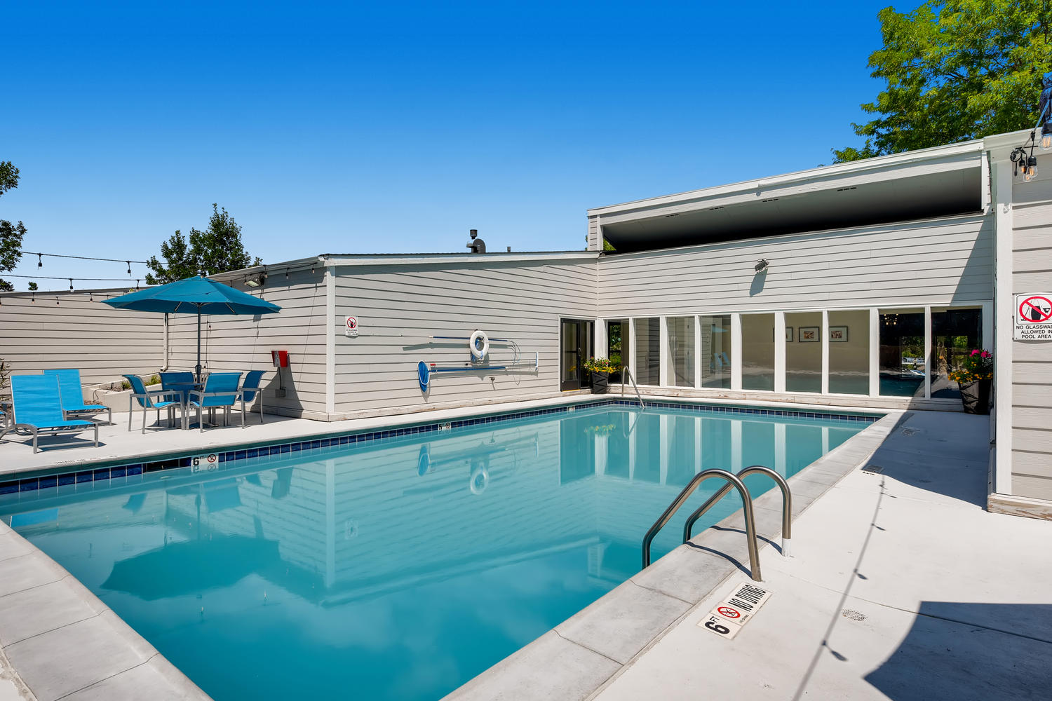 Sparkling swimming pool set on a sunny day at Villas at Holly in Centennial, CO.