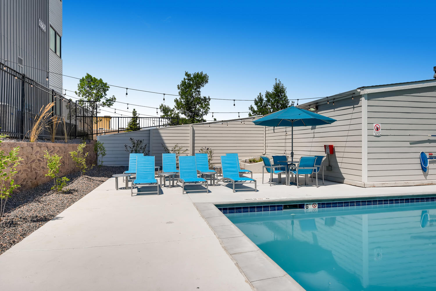 Swimming pool with blue lounge chairs