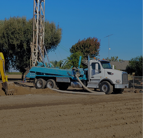 Domestic well drilling. Drill rig in front of a house.