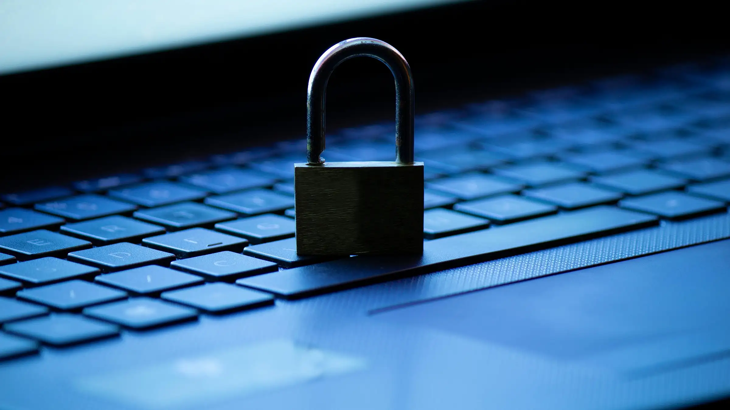 Close-up of a closed padlock resting on a laptop keyboard symbolizing cybersecurity.
