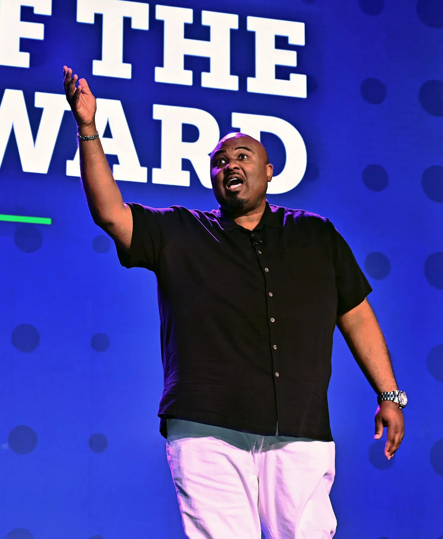 Wil Lewis gesturing onstage at the 2025 Disability:IN Conference.