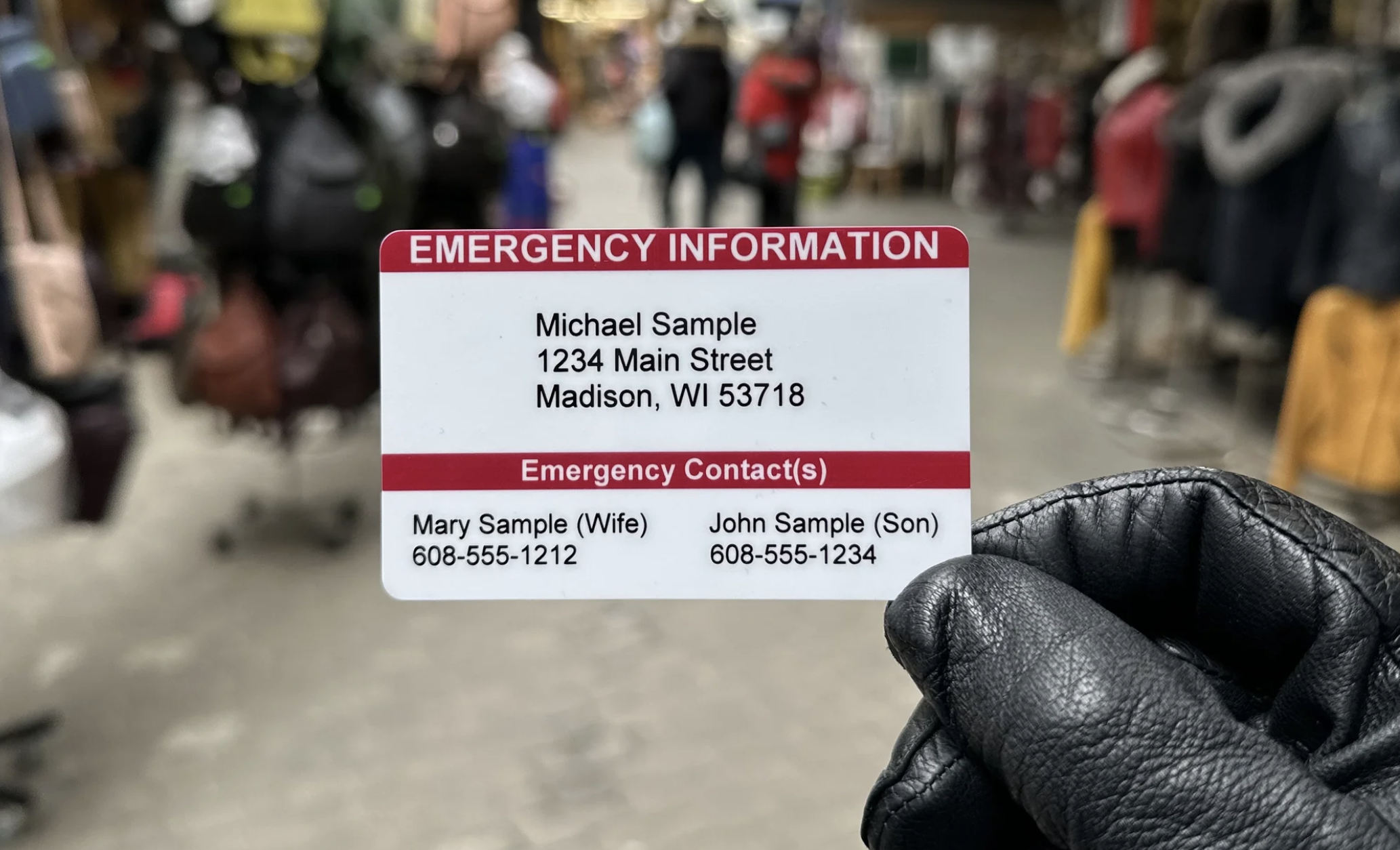 A hand olds up an in case of emergency card from secure ID.