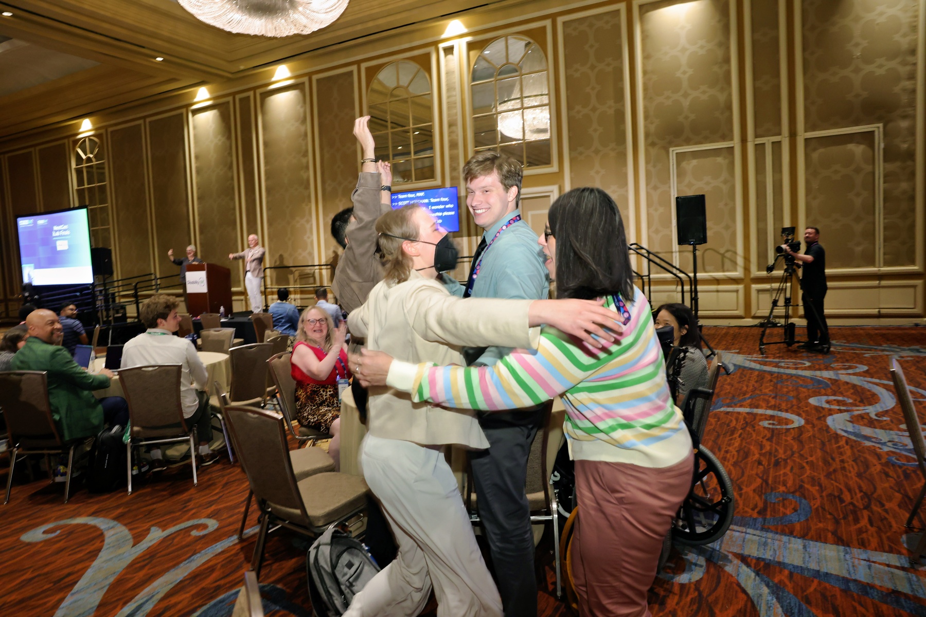 Nextgen leaders hug and cheer after they win their iLab competition at the conference