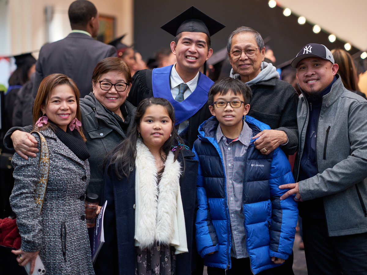 A Bow Valley College graduate with his family attending as guests to convocation