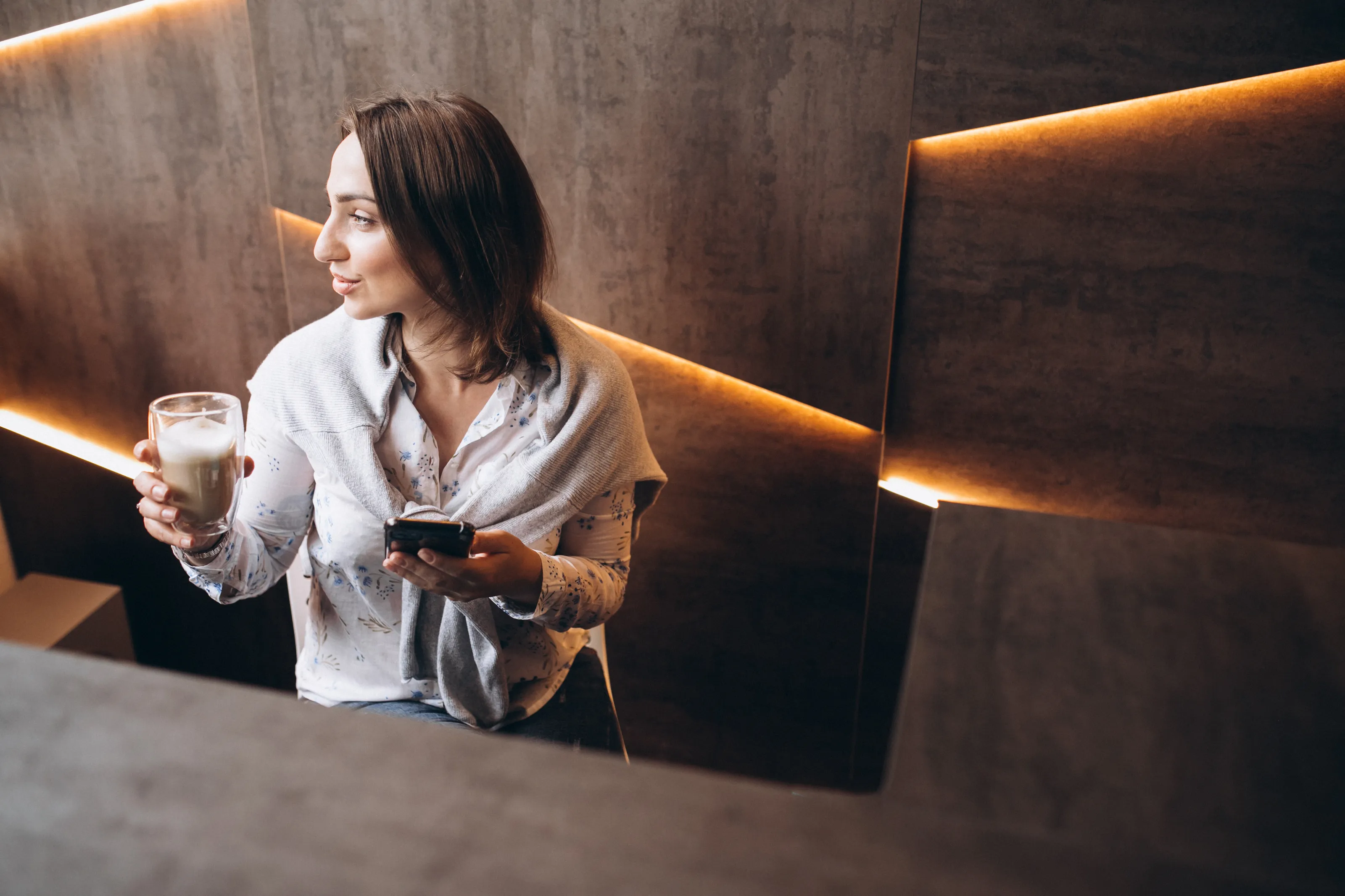 a woman holding a coffee cup