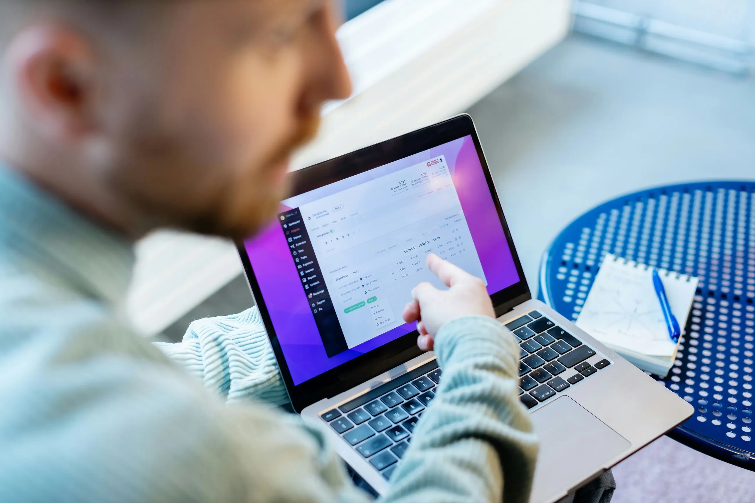 a person pointing at a computer