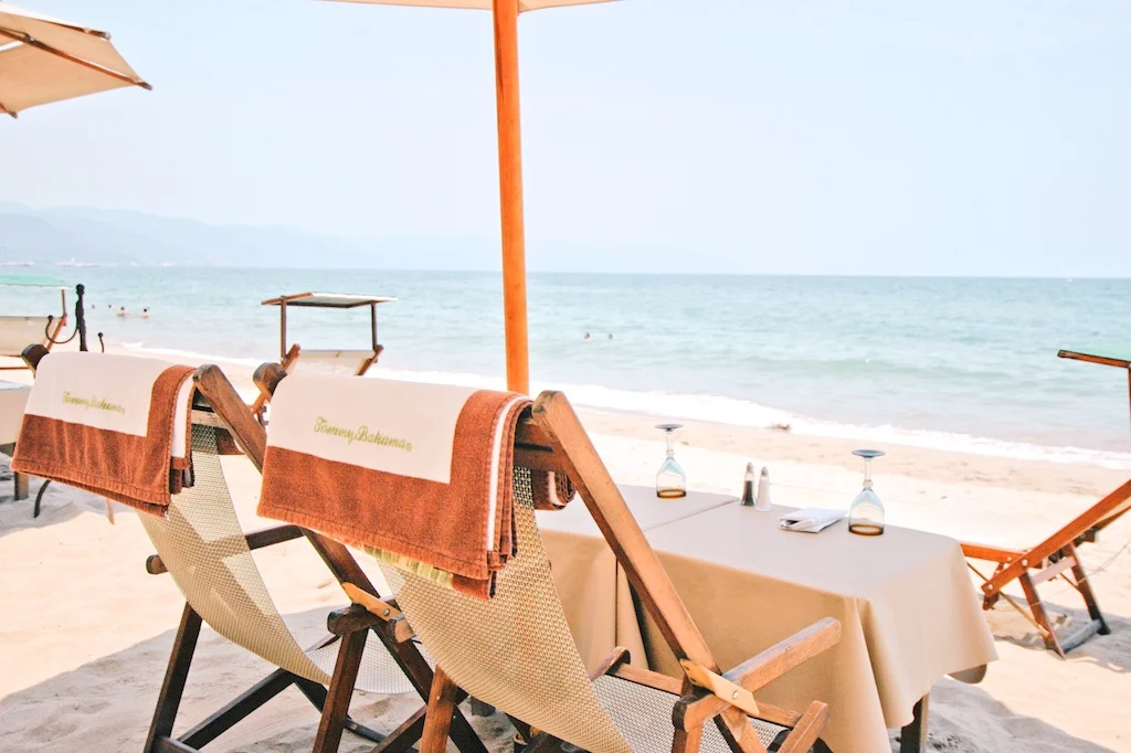 Beach club loungers and umbrellas on the sand at La Palapa, Puerto Vallarta