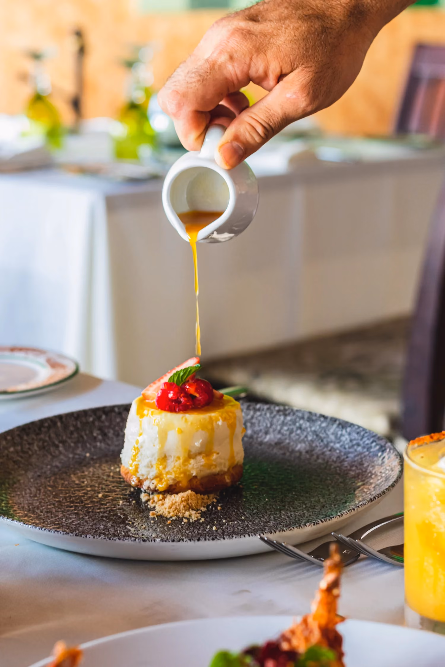 Sauce poured over a dessert at the table