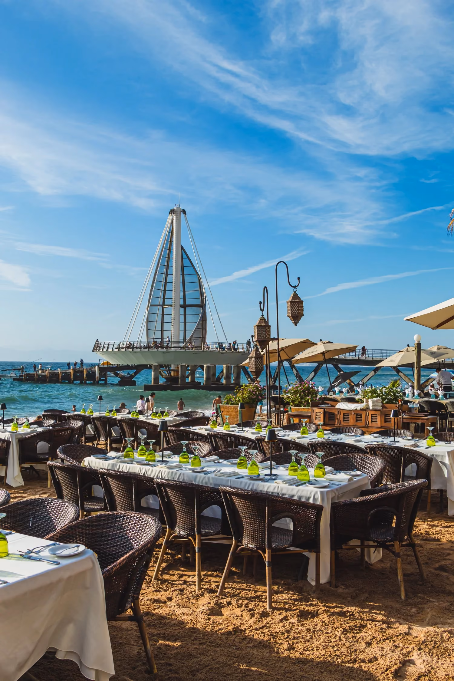 Tables set on the sand by the Los Muertos Pier in the morning