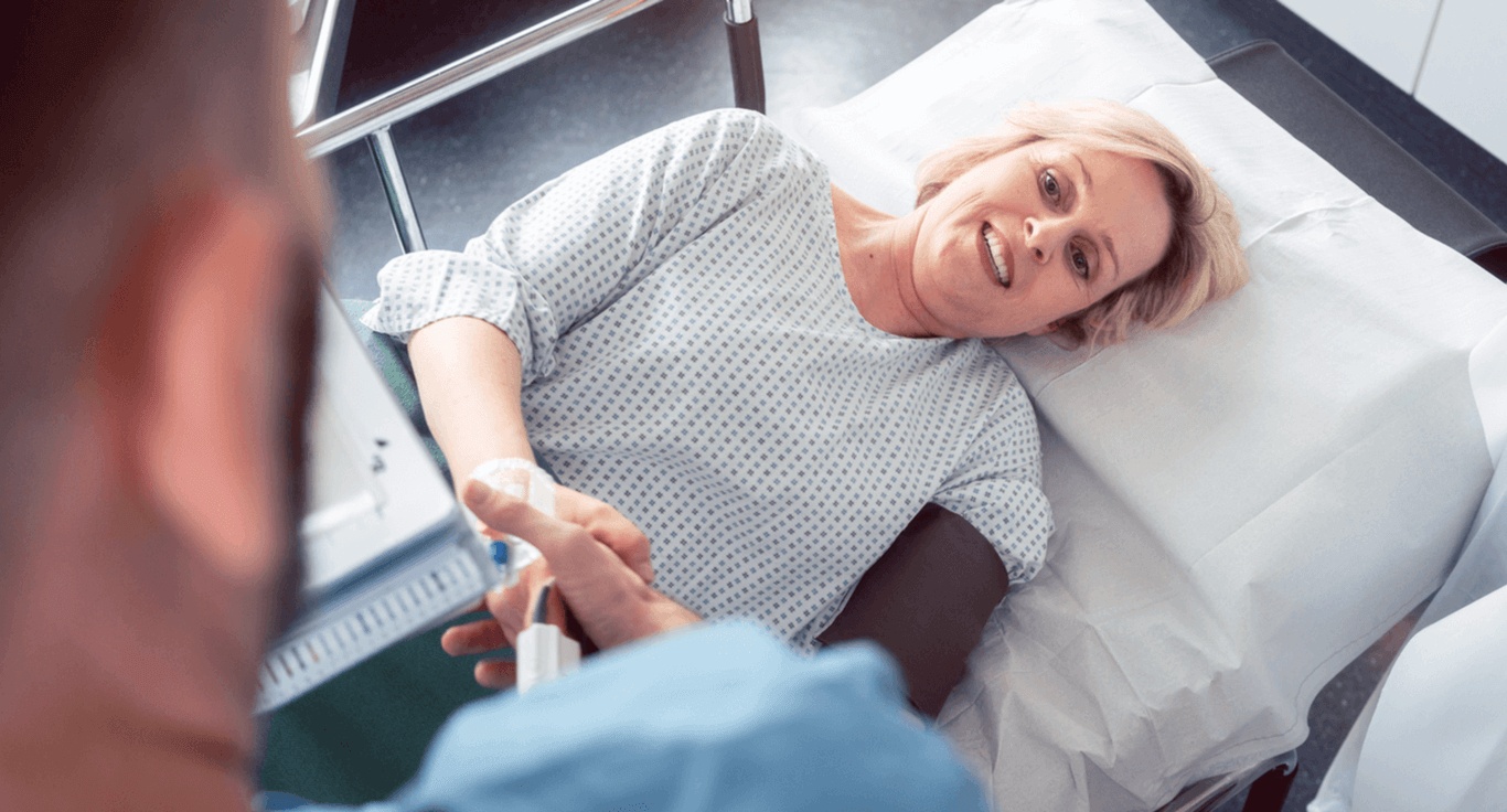 A woman in a hospital bed shakes hands with her doctor as she prepares for a GI diagnostic test in Los Angeles