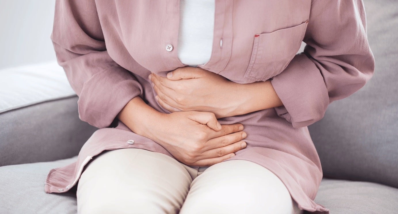 Woman experiencing abdominal pain from an IBS flare-up while seeking care and treatment options from the best gastroenterologist in Los Angeles, CA.