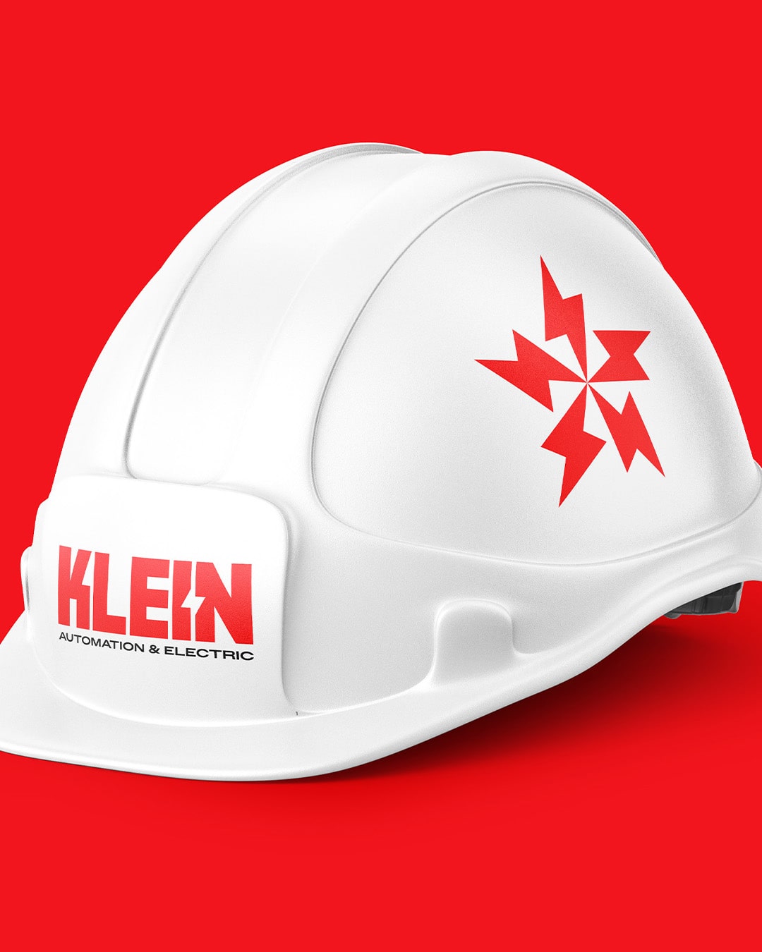 White construction hard hat with red lightning bolt logo and text saying Klein Automation & Electric on a red background.
