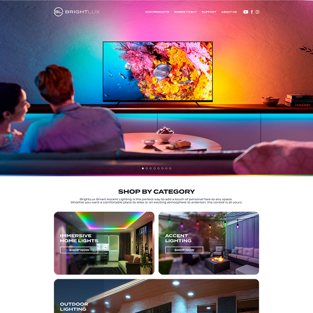 Couple sitting on a couch watching a TV with vibrant ambient lighting behind it, showcasing a colorful coral reef scene.