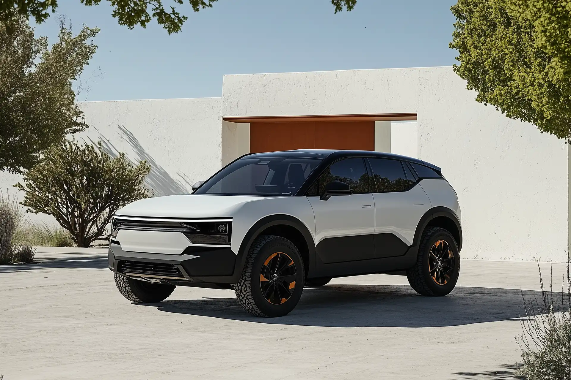 White and black modern SUV with orange-accented wheels parked in front of a white building with large trees around.