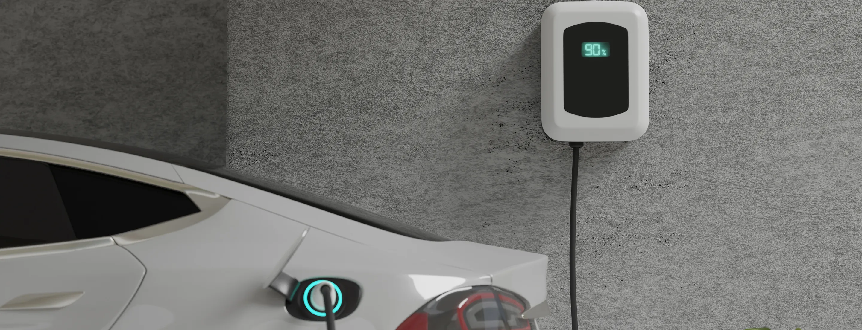 White electric vehicle charger mounted on concrete wall showing 90% charge on digital display