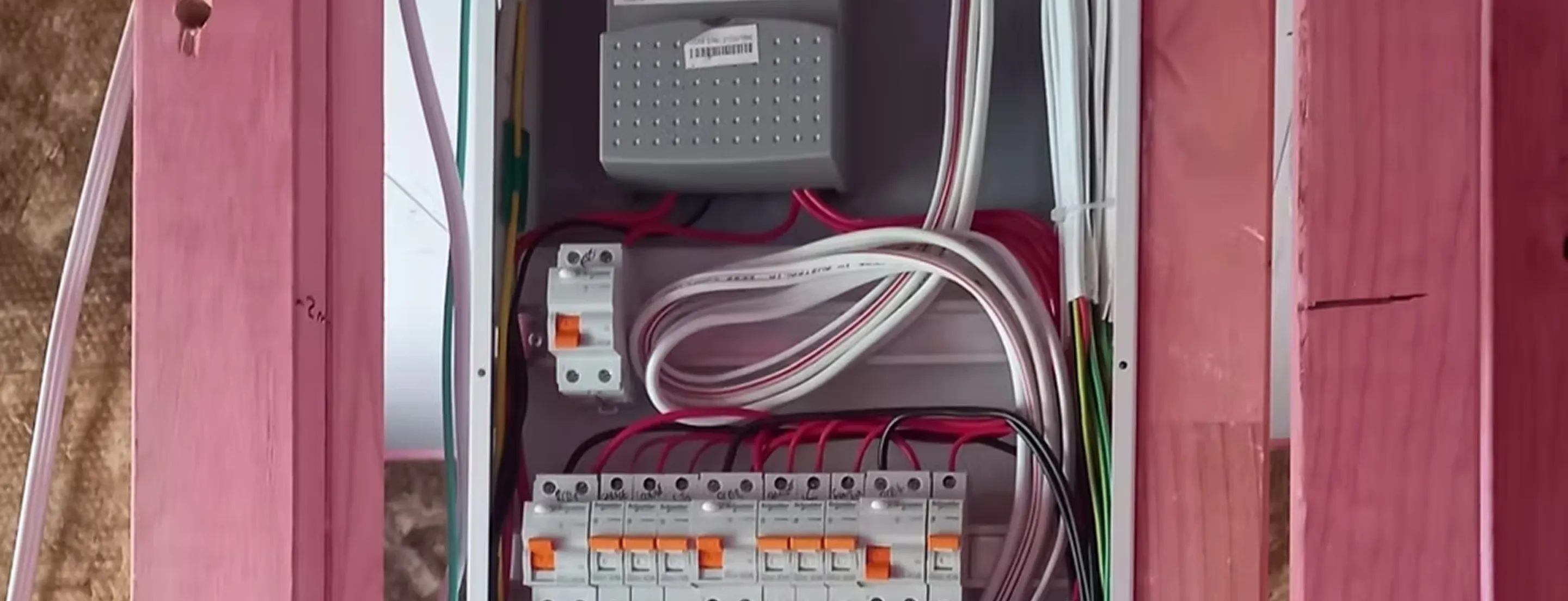 Electrical testing equipment including yellow multimeter and test probes on technical drawings