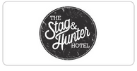 The Stag & Hunter Hotel logo featuring stylized white text on a black circular background.