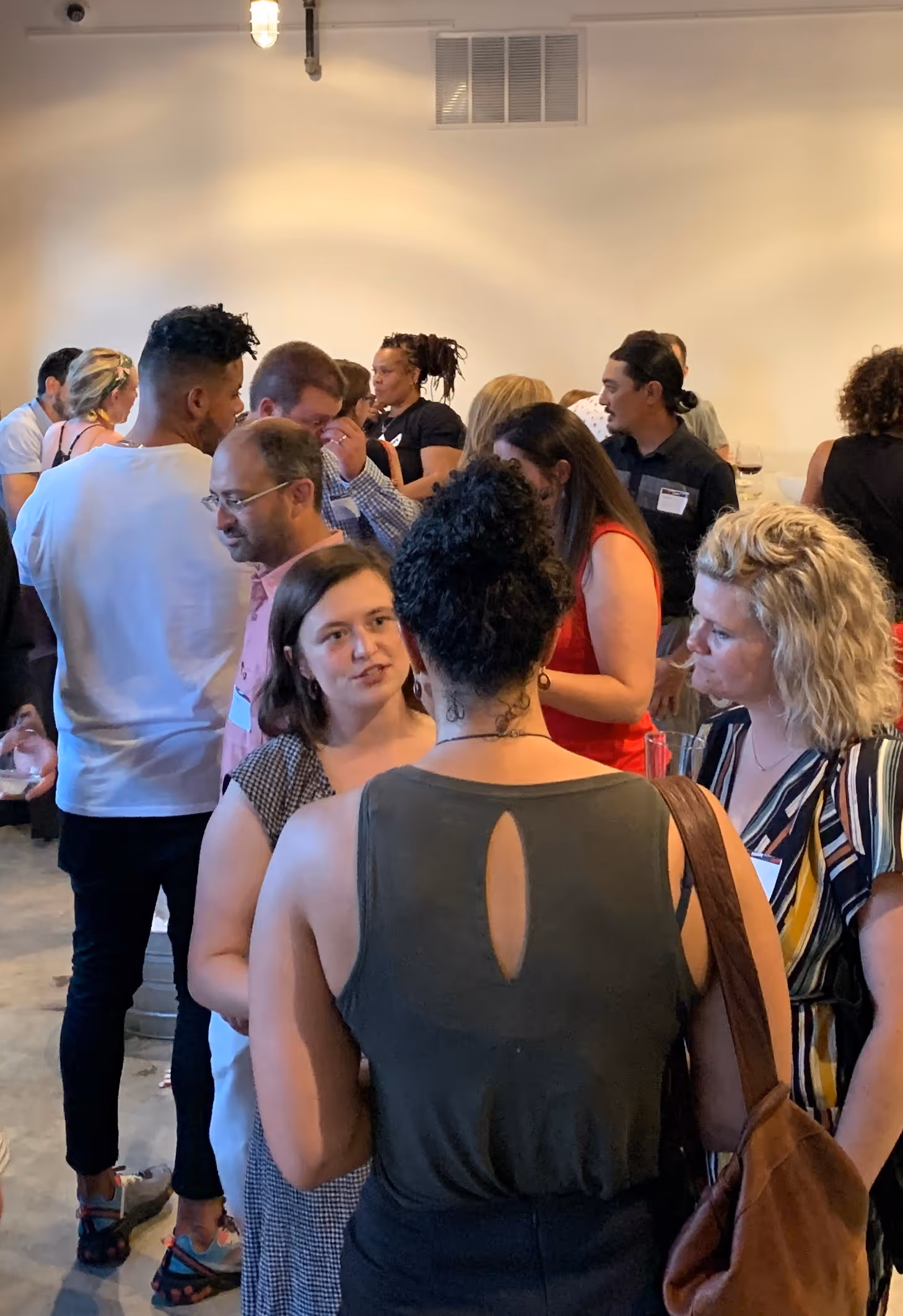 A room of people from mission-driven organizations share ideas and insights on social impact.