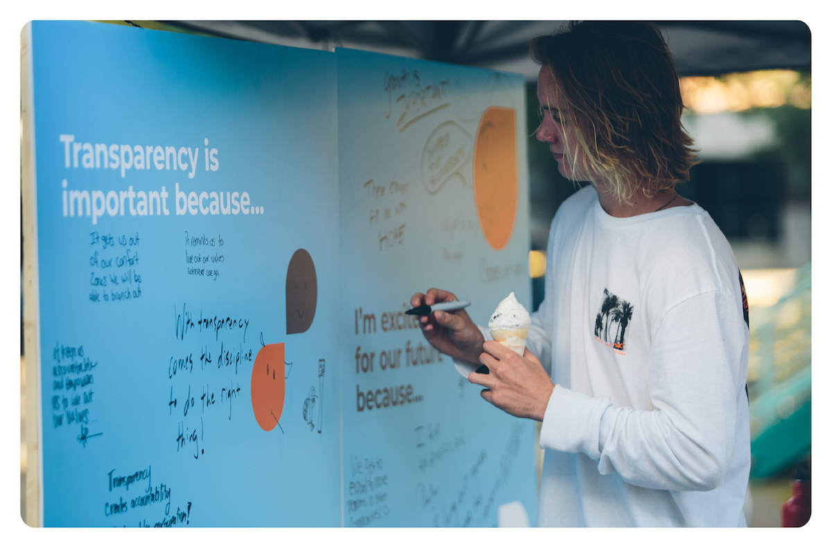 Clearwater Credit Union member adding her response to "Transparency is important because..." to a community poster board