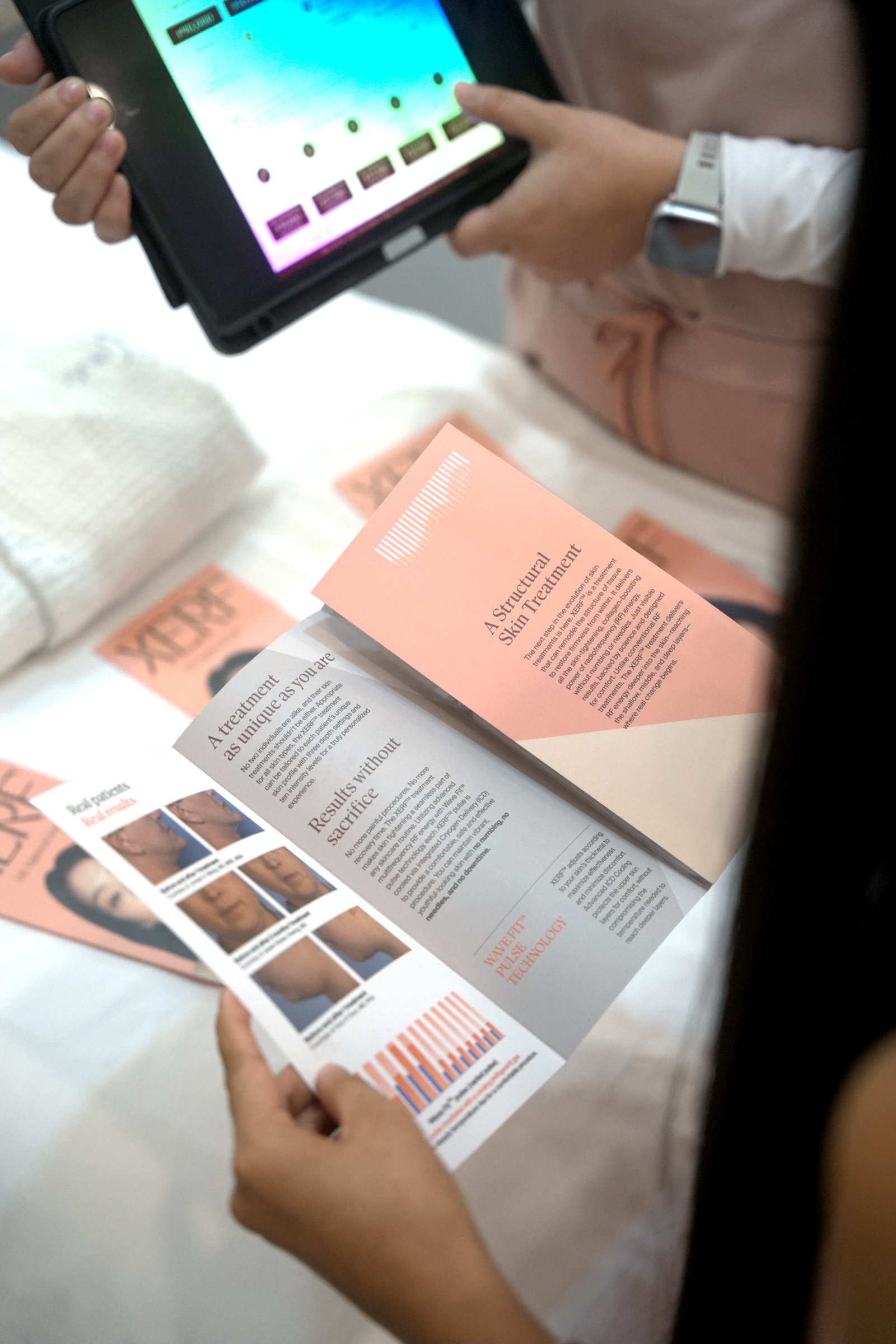A guest reads the XERF material while a member of the clinic team works through the treatment settings.
