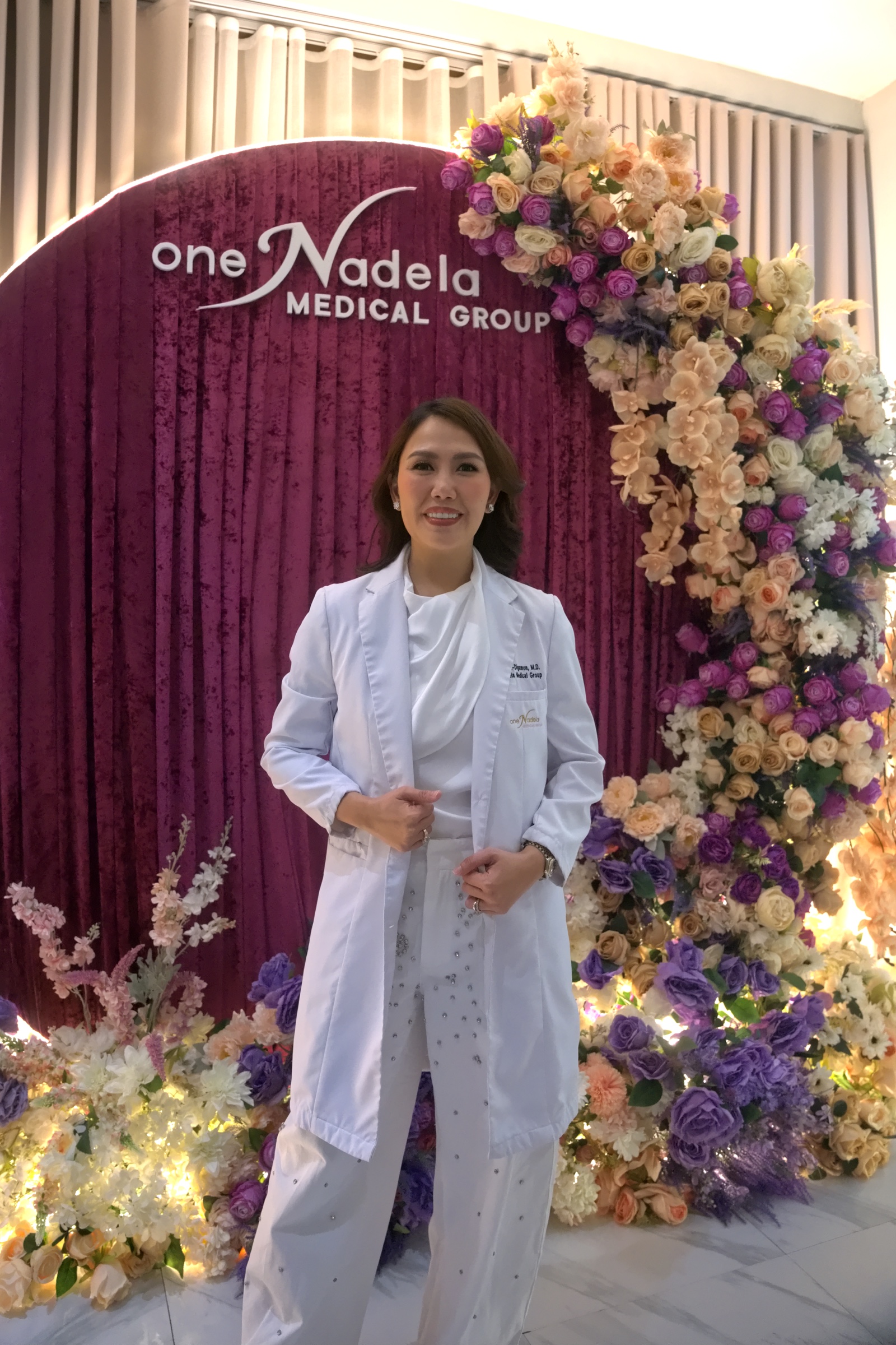 Dr. Pallas Athena Nadela-Digamon at the anniversary backdrop.