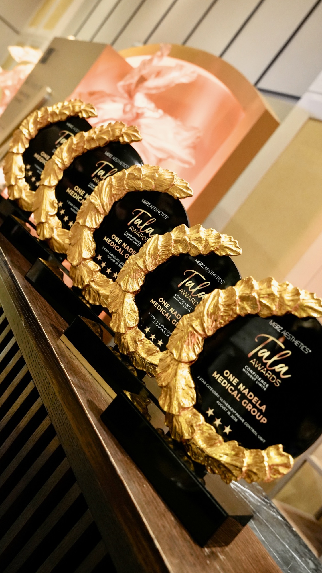 The trophies carry the award category and the date, 19 August 2026.