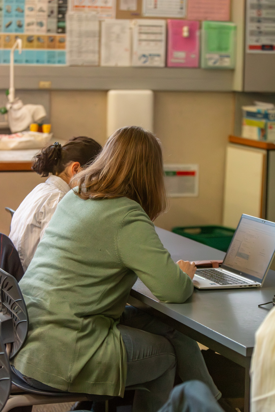 Teacher and student work together at a desk