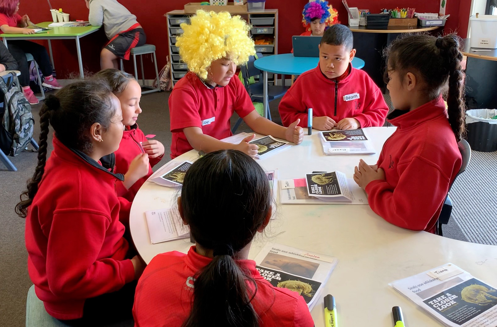 Students sit around at desk at Viscount School